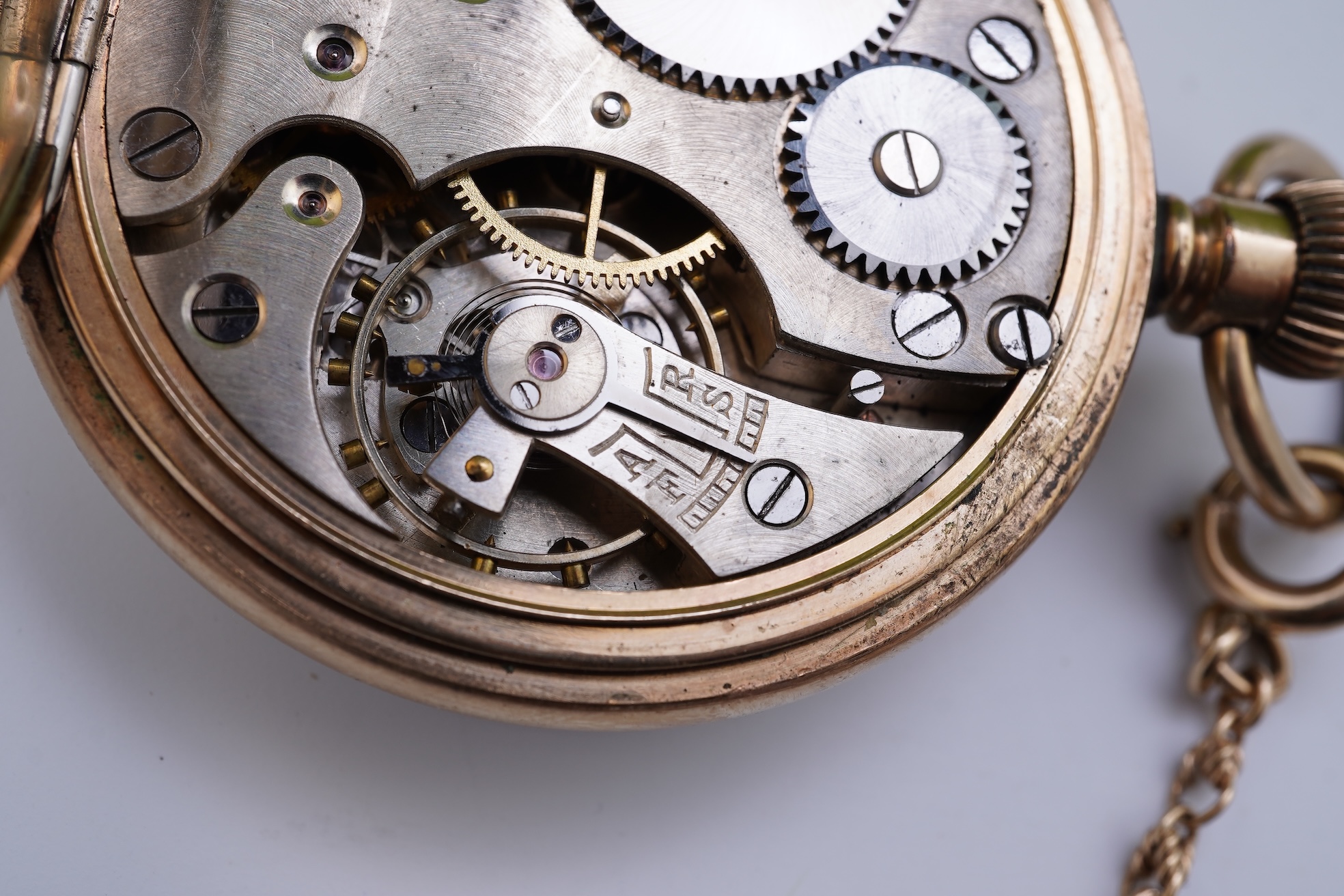 An amethyst fob seal, a gold Albert chain, and a pocket watch